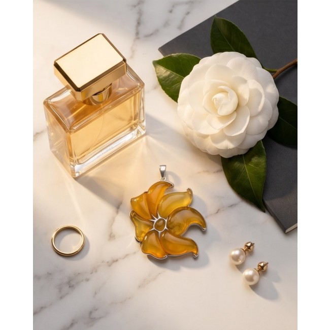 Golden Wild Lotus Natural Butterscotch Baltic Polish Amber .925 Sterling Silver dipped in rhodium handcrafted Pendant - Flat lay of jewelry with golden lotus pendant and perfume bottle.