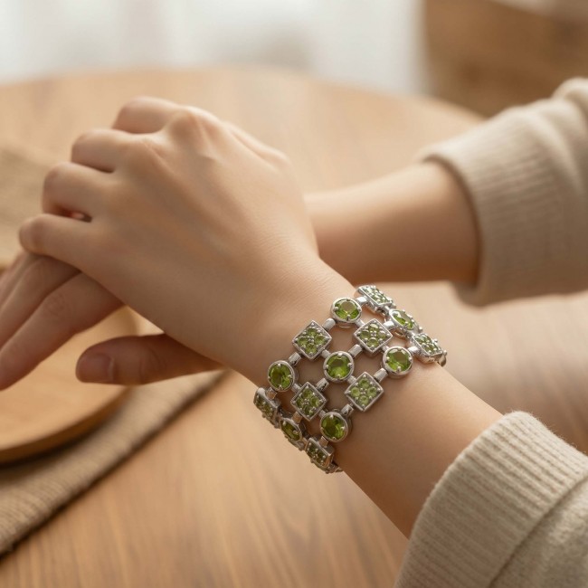 Vittoria Natural 27.8 carat Brazilian Peridot Rhodium over .925 Sterling Silver handmade Statement Bracelet - Peridot bracelet worn on wrist, showing decorative front detail.