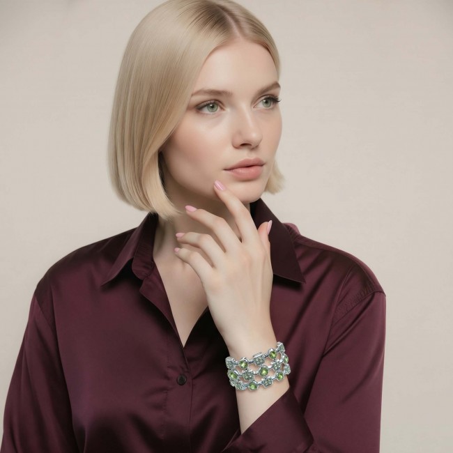 Vittoria Natural 27.8 carat Brazilian Peridot Rhodium over .925 Sterling Silver handmade Statement Bracelet - Woman wearing Vittoria peridot bracelet, front view, maroon shirt.