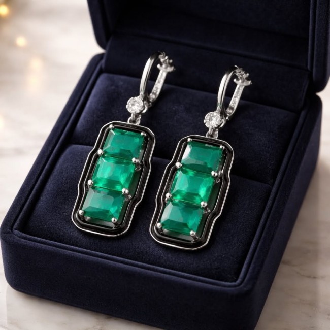 Art Deco 8.5 carat Emerald black enamel .925 Sterling Silver handcrafted earrings - Emerald earrings in box, close-up view, Art Deco style.