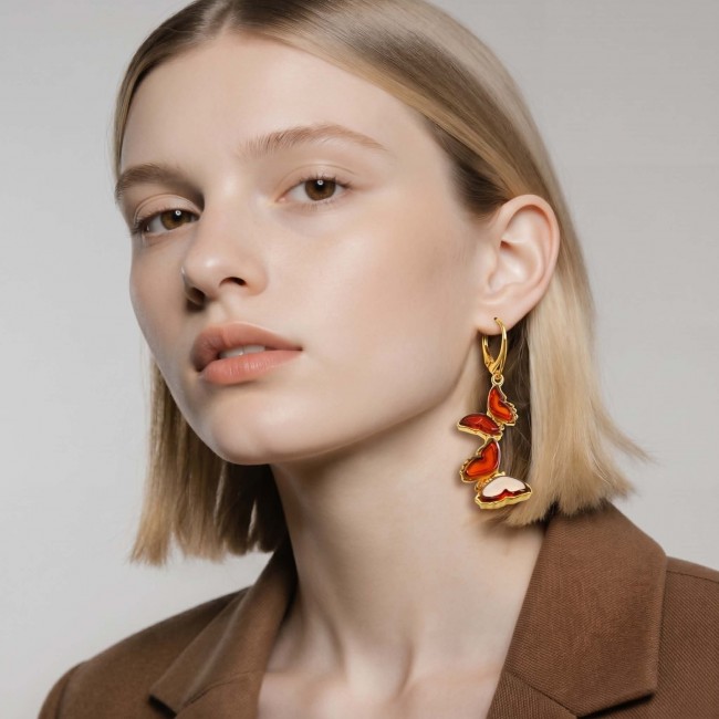 Butterflies carved Baltic Polish Amber 18K Gold over .925 Sterling Silver handcrafted earrings - Earrings worn side view, butterflies carved Baltic Polish Amber 18K Gold.