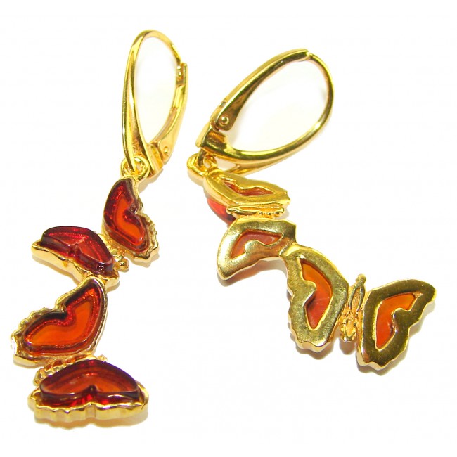 Butterflies carved Baltic Polish Amber 18K Gold over .925 Sterling Silver handcrafted earrings - Butterfly amber earrings in 18K gold over silver, angled front view.
