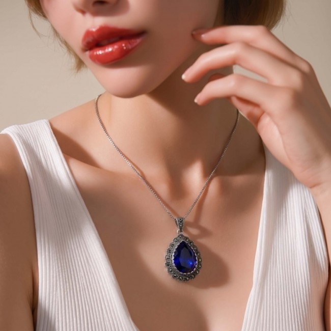 Julietta 14.5 carat London Blue Topaz Marcasite .925 Sterling Silver handmade Statement Pendant - Necklace worn, showcasing blue topaz pendant close-up.