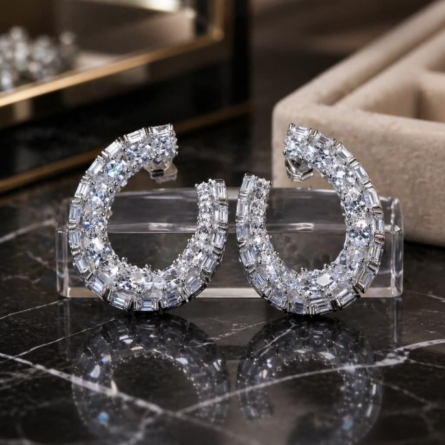 Allure Natural 8.2 carat White Topaz .925 Sterling Silver handcrafted hoop earrings - Front view of hoop earrings with white topaz on black marble surface.