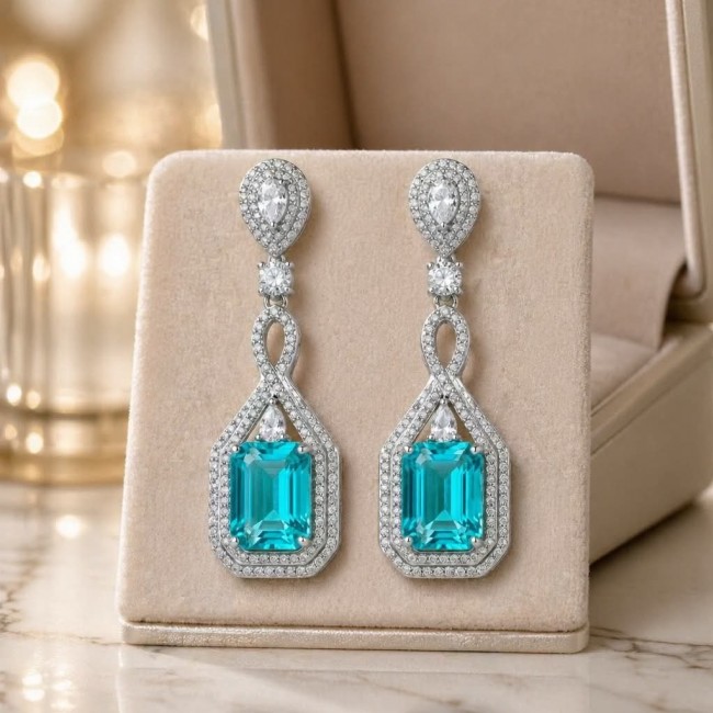 Incredible 10.5 carat Paraiba Tourmaline .925 Sterling Silver entirely handmade earrings - Paraiba Tourmaline earrings front view on display with intricate details.