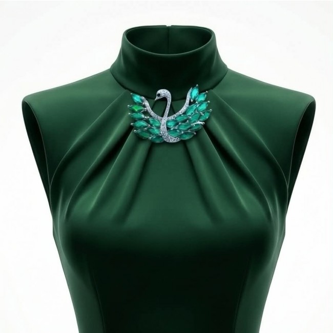 Graceful Swan Genuine 19.5 carat Colombian Emerald .925 Sterling Silver handmade Pendant - Brooch - Close-up of Graceful Swan brooch on green fabric dress display