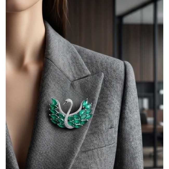 Graceful Swan Genuine 19.5 carat Colombian Emerald .925 Sterling Silver handmade Pendant - Brooch - Emerald swan brooch worn on grey blazer, front view.