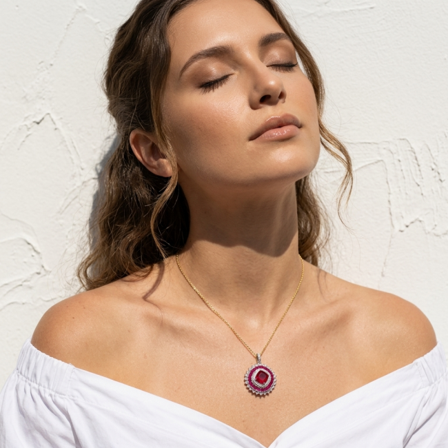 Art Deco - Bella Rosa Genuine 5.8 carat Ruby .925 Sterling Silver dipped in rhodium Statement brilliantly handcrafted Pendant - Woman wearing Art Deco Bella Rosa Ruby necklace, eyes closed.
