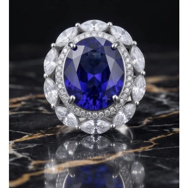 Precious Design oval cut 24.9 CARAT Tanzanite .925 Sterling Silver Statement Ring s. 5 1/4 - Tanzanite ring with diamond halo, front view, on marble background.