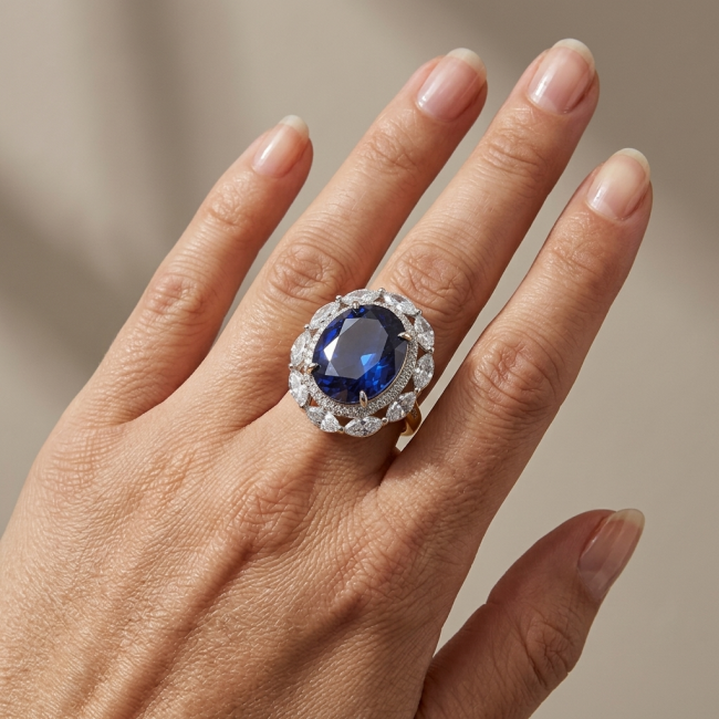 Precious Design oval cut 24.9 CARAT Tanzanite .925 Sterling Silver Statement Ring s. 5 1/4 - Tanzanite ring worn on hand, oval cut, surrounded by diamond accents.