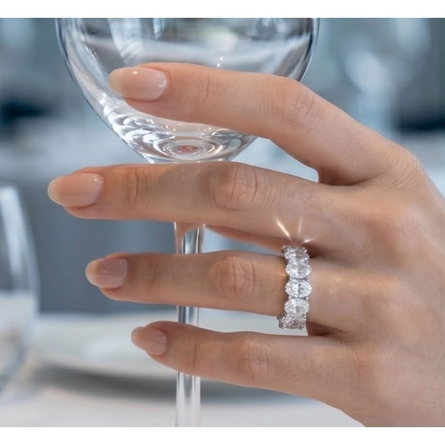 Luxurious 6.5 carat White Topaz .925 Sterling Silver infinity ring size 6 3/4 - Hand wearing luxurious 6.5 carat topaz ring holding a wine glass
