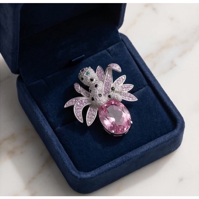Pink Cheetah authentic 12.5 carat Swiss Blue Topaz .925 Sterling Silver Handcrafted pendant brooch - Jewelry piece with pink topaz in an open blue velvet box, top view.