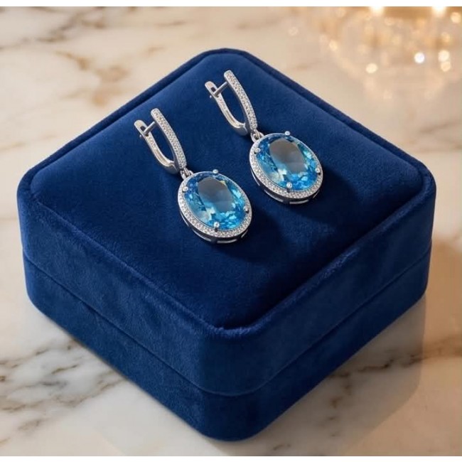 Eau Pure 18.5 carat Swiss Blue Topaz .925 Sterling Silver Handcrafted Earrings - Eau Pure Swiss Blue Topaz earrings on a blue velvet box, top view.