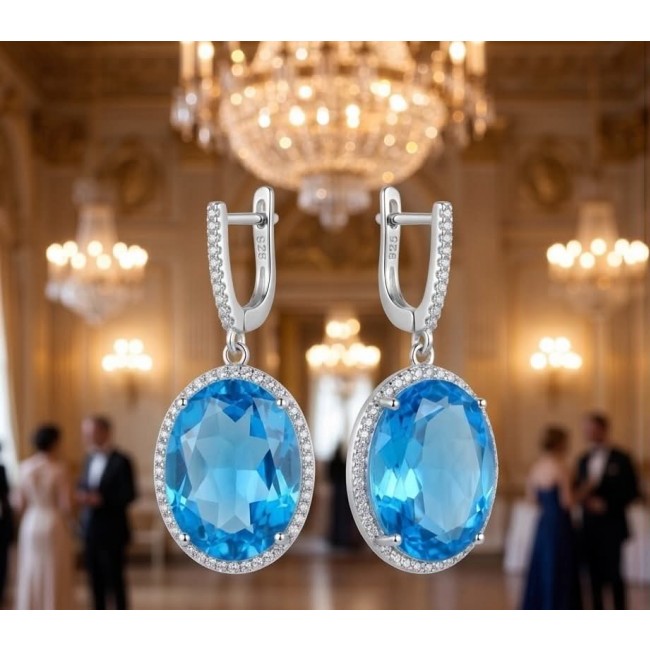 Eau Pure 18.5 carat Swiss Blue Topaz .925 Sterling Silver Handcrafted Earrings - Blue topaz earrings front view, sterling silver setting, elegant background.
