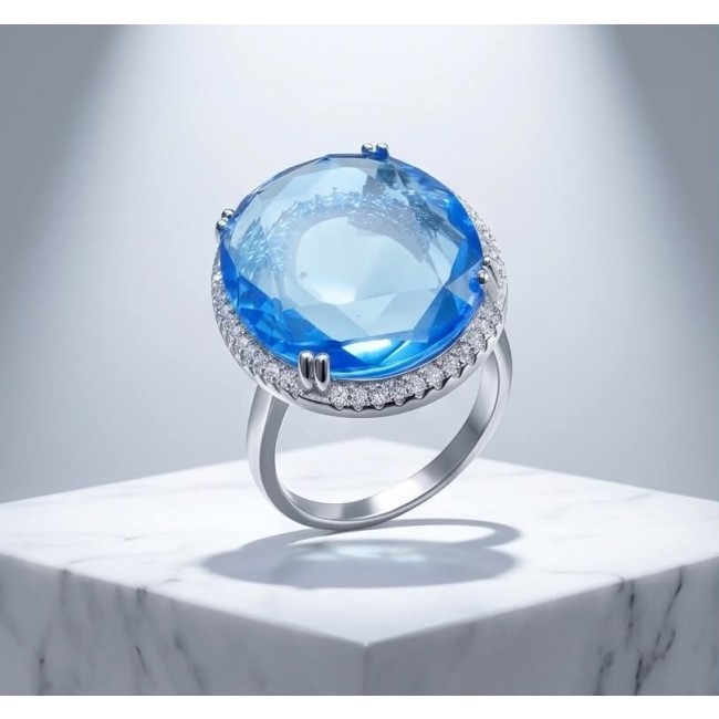 Eau Pure 14.5 carat Swiss Blue Topaz .925 Sterling Silver Handcrafted Statement Ring size 8 - Close-up of Swiss Blue Topaz ring on marble display, side view.