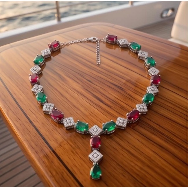 Ginevra - Luxurious natural 18.4 carat Ruby Emerald .925 Sterling Silver handmade Statement necklace - Necklace on table, featuring rubies, emeralds, and .925 silver settings.