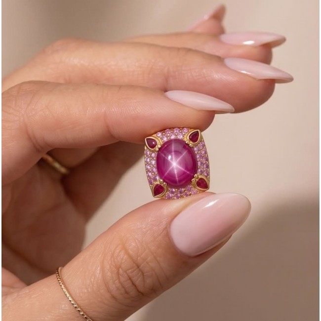 Red Cascade 16.2 carat Star Ruby .925 Sterling Silver dipped in real 22K Gold brilliantly handcrafted earrings - Close-up of Red Cascade 16.2 carat Star Ruby held between fingers.