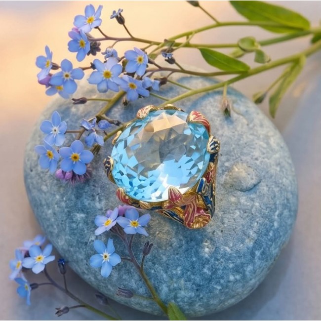 Poseidon 65.3 carat Swiss Blue Topaz ENAMEL .925 Sterling Silver dipped in 18K Gold handcrafted Large ring size 7 - Blue Topaz ring on stone with flowers, top-down view.