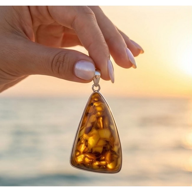 Prehistoric Authentic Baltic Amber .925 Sterling Silver beautifully handcrafted Pendant - Baltic amber pendant close-up with sunset background.