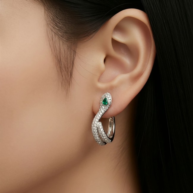 Cobra SNAKE Emerald White Sapphire Snakes 0.5 carat Emerald .925 Sterling Silver earrings - Earring with emerald and sapphires, worn on ear, side view.