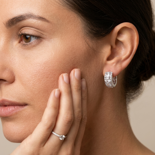 Stella Natural 6.2 carat White Topaz .925 Sterling Silver handcrafted earrings - Woman wearing Stella earrings and ring, side view close-up.