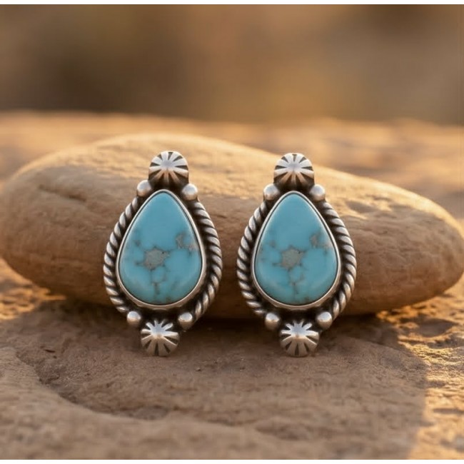 Great authentic Morenci Turquoise .925 Sterling Silver handcrafted Earrings - Turquoise silver earrings front view on rock background.