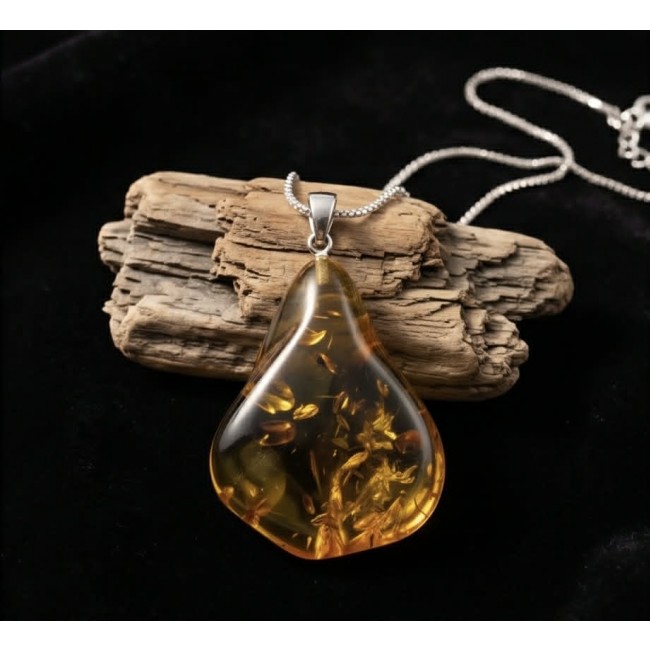 Sea Treasure Prehistoric Authentic Baltic Amber .925 Sterling Silver beautifully handcrafted Pendant - Baltic amber pendant with silver chain, displayed on driftwood.