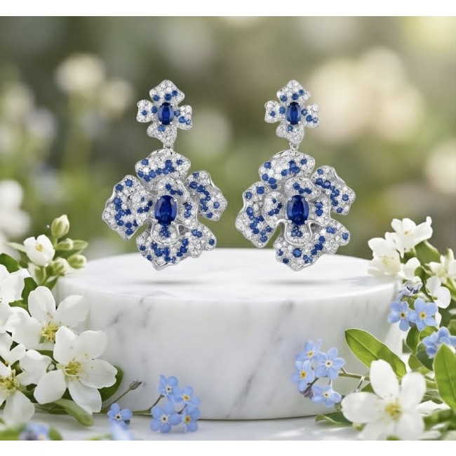 Oceania - 9.5 carat Sapphire .925 Sterling Silver dipped in Rhodium handmade Statement earrings - Floral sapphire earrings on marble, front view with floral accents