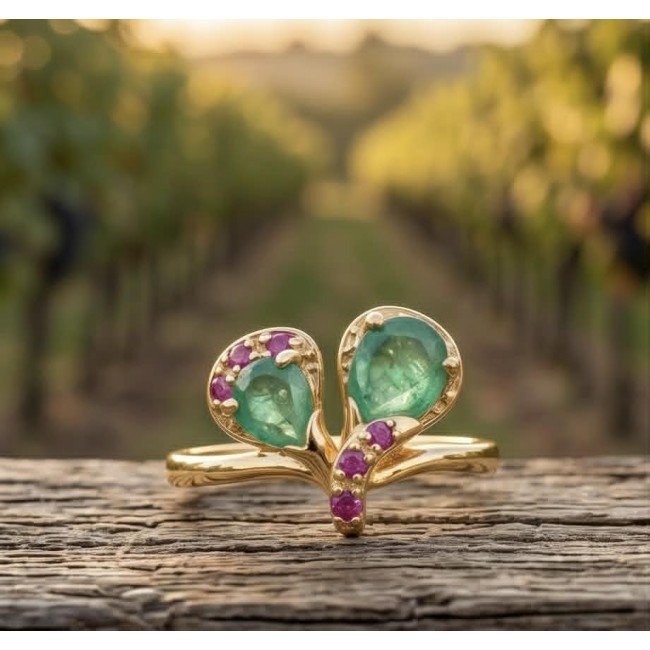 Gabriella 2.7 carat authentic Emerald 18K Gold over .925 Sterling Silver handcrafted Statement Ring size 8 - Front view of Gabriella emerald ring with pink accents on rustic wood.