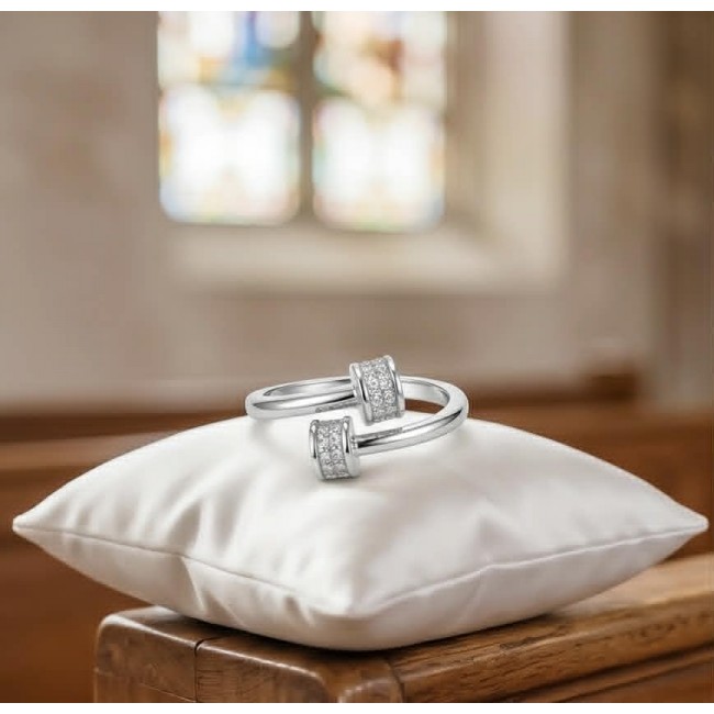 Luxurious pave 1.5 carat White Topaz .925 Sterling Silver Solid Infinity ring size 7 - White Topaz rings on pillow in church setting, focus on design detail.