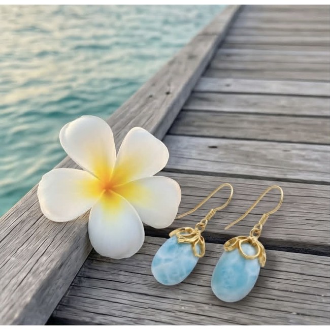 Genuine 10.5 carat Blue Larimar 14K Gold over .925 Sterling Silver handmade earrings - Blue Larimar earrings on dock with frangipani flower, ocean background