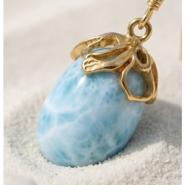 Genuine 10.5 carat Blue Larimar 14K Gold over .925 Sterling Silver handmade earrings - Close-up of Blue Larimar pendant in 14K gold on sandy surface.