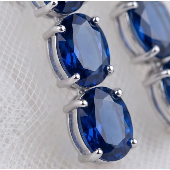 Deep Ocean 22.5 carat London Blue Topaz .925 Sterling Silver handmade Statement earrings - Close-up of London Blue Topaz stones in sterling silver settings.