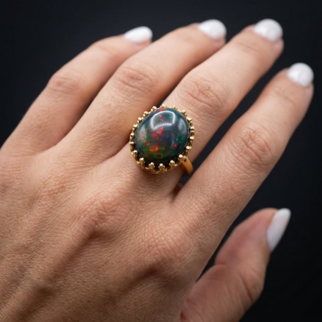 Exotic Beauty Genuine 24.2 carat Black Opal 18K Gold over .925 Sterling Silver handmade Ring size 8 1/4 - Black opal ring in 18K gold, worn on hand, showcasing stone brilliance.