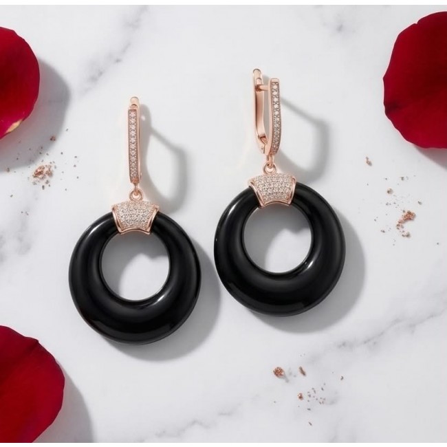 Outstanding authentic Onyx .925 Sterling Silver dipped in 18K Rose Gold Earrings - Black Onyx earrings with rose gold accents on marble, top view.