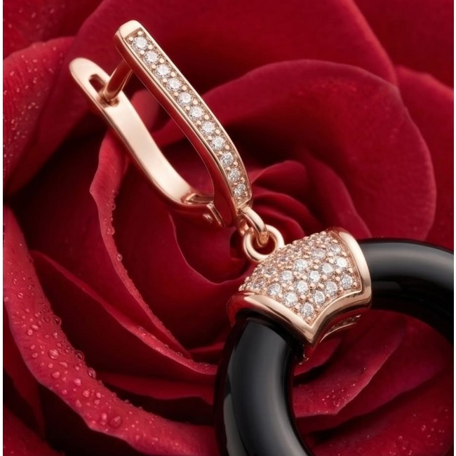 Outstanding authentic Onyx .925 Sterling Silver dipped in 18K Rose Gold Earrings - Close-up of onyx earring with diamond detail on red rose background.