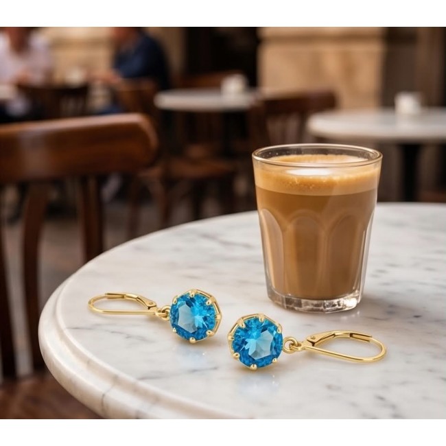 Atlantica 6.8 carat Swiss Blue Topaz 22K Gold over .925 Sterling Silver Handcrafted Statement earrings - Swiss Blue Topaz earrings and coffee on marble table, top view.