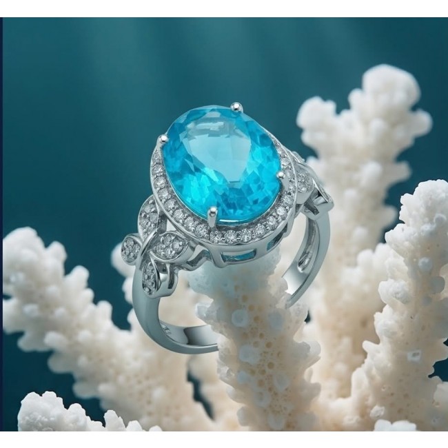 WONDERLAND 14.5 carat Paraiba Tourmaline .925 Sterling Silver Handcrafted Ring size 7 3/4 - Side view of a Paraiba Tourmaline ring on coral background.