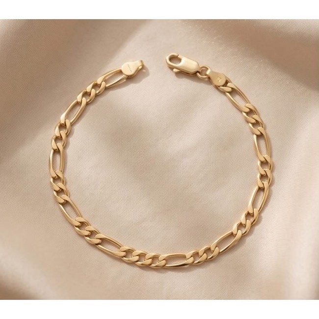 Authentic Figaro design 18K Gold over .925 Sterling Silver handmade Bracelet - 18K gold Figaro bracelet on fabric, showcasing clasp and chain detail.
