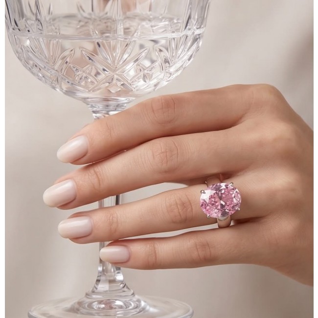 Tiffany - authentic 14.5 carat Pink Sapphire .925 Sterling Silver Handcrafted Statement Ring size 8 - Pink sapphire ring on hand holding a crystal glass, close-up view.