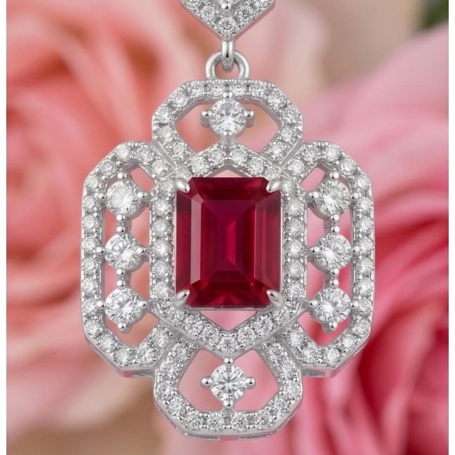Carolyn - authentic 6.4 carat Ruby .925 Sterling Silver dipped in rhodium handcrafted Statement earrings - Close-up of Carolyn ruby pendant with diamond accents on silver backdrop