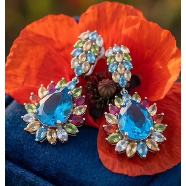 Atlantica 33.7 carat Swiss Blue Topaz .925 Sterling Silver dipped in rhodium Handcrafted Statement earrings - Close-up of Atlantica Swiss Blue Topaz earrings on red flower.