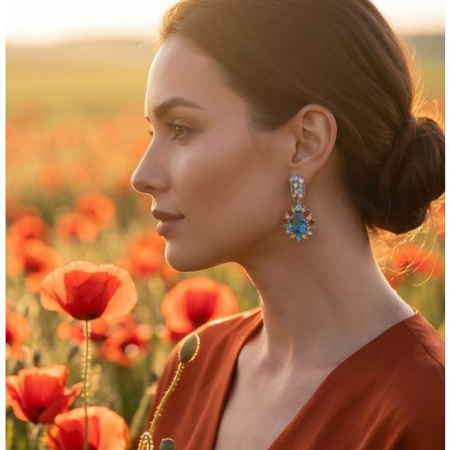Atlantica 33.7 carat Swiss Blue Topaz .925 Sterling Silver dipped in rhodium Handcrafted Statement earrings - Side view of Swiss Blue Topaz earrings worn by a woman in a poppy field.