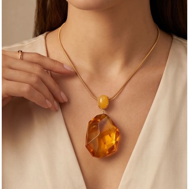Wonderful Perfection real faceted Elegant Genuine Golden Baltic Amber 22K Gold over .925 Silver handcrafted Necklace - Necklace with large amber stone worn on model's neck, close-up view.