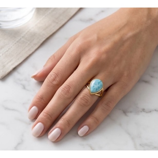 Treasure of Dominican Republic 12.5 carat genuine Larimar .925 Sterling Silver dipped in 22K Gold over Handcrafted Ring size 6 - Larimar ring worn on hand, showing stone and gold band on marble surface.