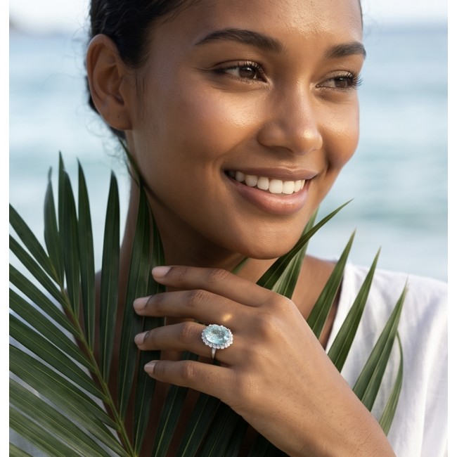 Angelina 14.9 carat authentic Aquamarine .925 Sterling Silver Handcrafted Ring size 7 - Woman wearing Angelina Aquamarine ring, hand near face, beach backdrop.