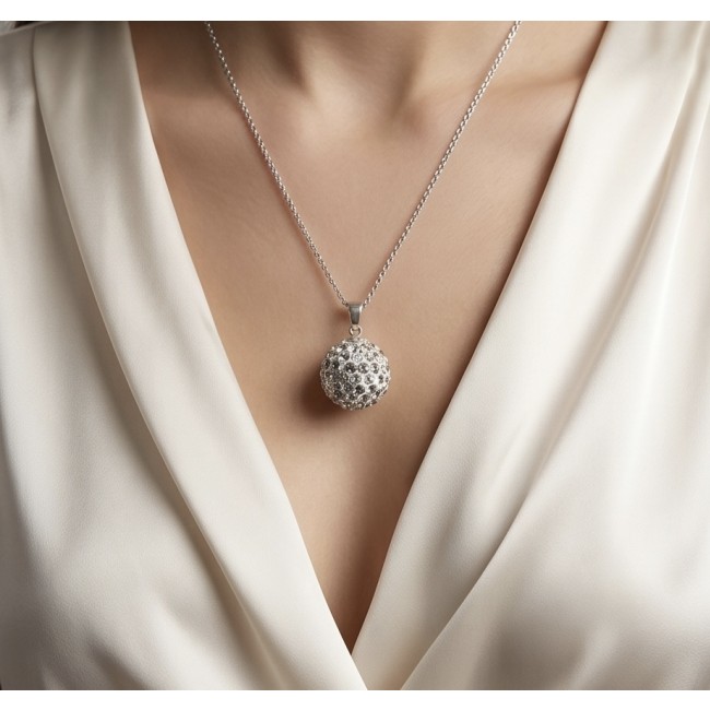 Harmony Sphere with bell inside pave Topaz .925 Sterling Silver handmade pendant - Worn Harmony Sphere necklace with topaz on a person in white blouse。