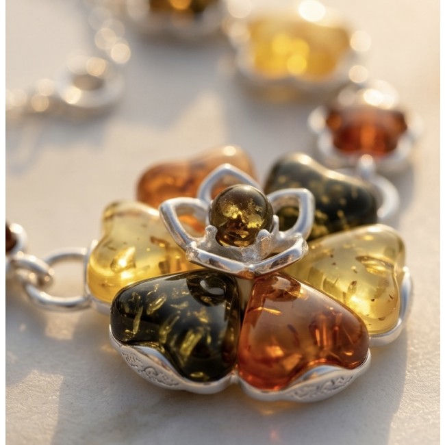 Floral design - natural multicolor Baltic Amber .925 Sterling Silver handcrafted necklace - Close-up of multicolor Baltic amber floral pendant with silver detail.