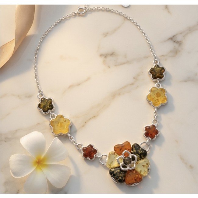 Floral design - natural multicolor Baltic Amber .925 Sterling Silver handcrafted necklace - Floral necklace with multicolor Baltic amber, top view on marble surface.