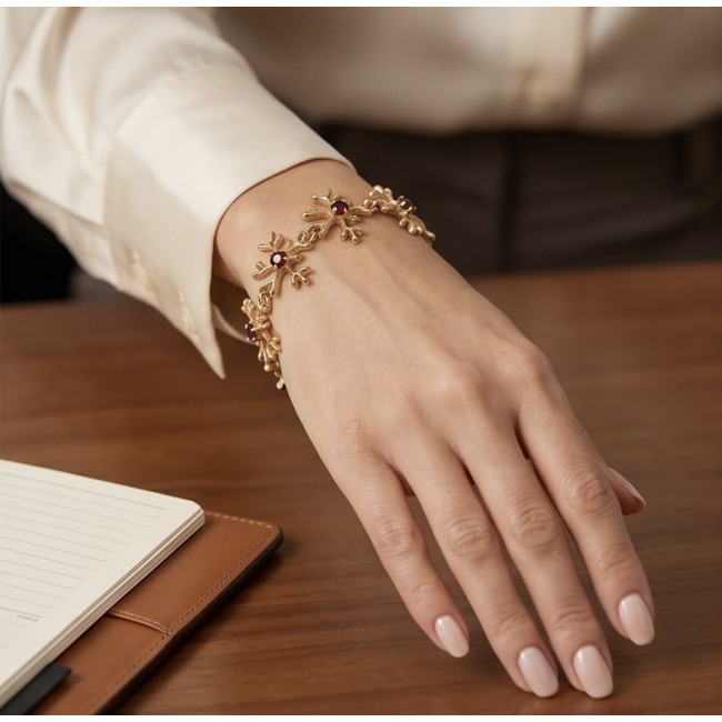 Authentic 5.2 carat Garnet .925 Sterling Silver dipped in real 14K rose gold handmade Bracelet - Bracelet worn on wrist, ornate design with garnet accents.